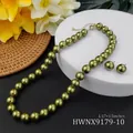 Detailed view of olive green pearl necklace and earring set on white pedestal - Olive Green (HWNX9179-10)