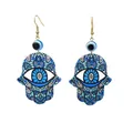 Detailed macro view of acrylic Hamsa Hand earrings with Evil Eye and blue beads - Blue Sunflower Pattern