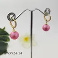 Dettaglio dell'orecchino huggie dorato con zirconi incastonati e perla rosa pendente - Rosa Perlato (HWX924-14)