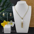 Detailed view of hollowed gold-tone tropical flower necklace with white shell pearl bead - White Bead(HWNX9439-15)