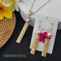 Close-up of gold hollow bar jewelry set with delicate pink pearls on a tropical display - Light Pink Style (HWNX9315-6)