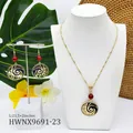 Detail view of wave-pattern necklace and earrings set with red pearls on a white display - Bright Red Pearl Style (HWNX9691-23)