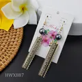 Macro shot of Polynesian tribal earrings with dark grey pearls on Aloha display card - Tribal Geometric Texture Rectangular Style (HWX887)
