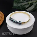 Detail of engraved gold bangle with black shell pearls on a tropical display base - Dazzling Black Style (HWB1057-1)