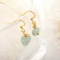 Detail of light green raw natural stone earrings with gold wire-wrapped hooks - Aventurine Gold