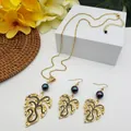 Tropical monstera leaf jewelry set with purple pearls and gold finish on white stand - Deep Purple Pearl Style (HWNX9484-1)