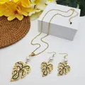 Detail of Monstera leaf jewelry set with gold plating, black enamel, and white pearls - White Pearl Style (HWNX9484-4)
