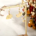 Detail of handmade gold earrings with natural irregular yellow crystal raw stones - Citrine