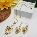 Detail of gold monstera leaf jewelry set with pink pearls and elegant braided texture - Light Pink Pearl Style (HWNX9484-6)