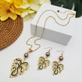 Macro shot of tropical monstera leaf jewelry set with brown beads and gold chain - Brown Pearl Style (HWNX9484-9)