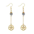 Macro detail of gold clover leaf drop earrings with grey pearl beads and fine chains - Cutout Clover Floral