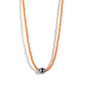 Macro view of orange beaded necklace featuring a large black pearl and gold spacers - Orange Beads Black Shell Pearl (Style 4)