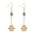Detailed view of long gold earrings featuring grey pearls and heart steering wheel charms - Heart Helm Style