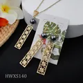 Golden hollow clover jewelry set with necklace, earrings and dark grey pearl accents - Necklace And Earrings Set (HWXS140)