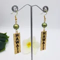 Detail of gold Hawaiian earrings featuring olive beads and engraved Hawaii text - Olive Green Bead Style (HWX1216-17)