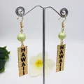 Detail of gold dangle earrings with green faux pearl and embossed Hawaii text pendant - Light Green Bead Style (HWX1216-20)