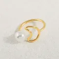Close-up of gold moon and star open ring with white pearl on white surface - Gold White Pearl Moon Style (AWM_8162)