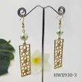Detail of gold geometric hollow drop earrings with light green pearls on display - Light Green Style (HWX930-3)