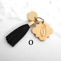 Detailed view of golden letter C clover charm with long black suede tassel accessory - Letter O-Gold Tassel