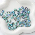 Faceted oval teal glass beads with iridescent AB coating on a white ceramic tray - Flat Oval 8x11mm, Hole Approx 1mm, 10 Pieces/Pack / Transparent Green