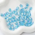 Faceted light blue oval crystal beads for DIY jewelry making on white ceramic tray - Flat Oval 8x11mm, Hole Approx 1mm, 10 Pieces/Pack / Transparent Light Blue