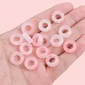 Hand holding pale pink translucent acrylic ring beads for DIY jewelry making - 14mm Inner Diameter Approx. 6mm Light Pink 500 Pieces/pack