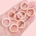 Handheld group of acrylic acetate rings with pink and orange marble texture effect - 23mm Inner Diameter Approx. 16mm Inner Diameter Pink 500 Pieces/pack