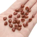 Brown triangular safety noses for DIY plush toys held in hand for size comparison - Brown / 7x9mm 100 Pieces/Pack