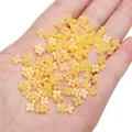 Bright yellow four-petal resin flower beads held in hand for DIY jewelry making - 5mm (20 Pieces/Pack) / Dark Yellow