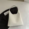 Minimalist white matte tote bag with embossed fashion text for versatile daily styling - White