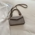 Brown textured leather crossbody bag with vintage embossed finish and knotted handle detail - Khaki