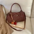 Retro brown suede tote bag with metal buckle belt and colorful pompom tassel on books - With Pendant / Coffee