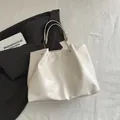 Creamy white faux leather tote bag with elegant gold chain and vertical stitching - White