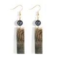 Detailed macro view of long drop earrings featuring carved black shell and gold hooks - Rectangular Geometric Pattern Style (HWB4323-1) / Iridescent Green Brown (HWB4323-1)