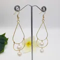 Detail of elegant gold-tone layered frame earrings with two white pearl accents - Pure White Pearl