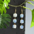 Handmade tulip drop earrings with blue marbled flower beads on a natural branch - Blue And White Gradient (HWX2727-2)