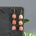 Detailed macro shot of handmade pink tulip drop earrings with three resin flower buds - Pink (HWX2727-3)