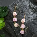 Detail of pink lily of the valley drop earrings with triple flower buds on gold wires - Pink Beige Gradient (HWX2727-4)