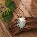 Iridescent shell leaf pendant on a black cord necklace with a tropical Hawaiian style - Leaf Style (HWBN240)