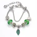 Green crystal beads and silver alloy leaf pendant charm bracelet with clover motifs - 16cm