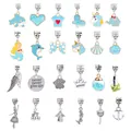 Detail of 24 light blue enamel and alloy charms featuring animals, crowns, and shells - Blue Assorted Style