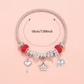 Detailed view of silver charm bracelet featuring crown and elephant pendants with 18cm size - Red