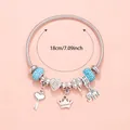 Detail of a 18cm pink heart charm bracelet with crown, clover and elephant pendants - Blue