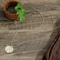 Detail of gold tropical coconut tree pendant with white shell inlay on a twisted chain - Coconut Tree Wave Style (HWBN992)