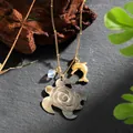 Hawaiian shell turtle necklace with golden dolphin pendant and blue bead on stone background - Turtle Dolphin Style (HWNX878ST-1)