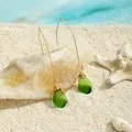 Makroaufnahme von handgefertigten Meerglas-Ohrringen mit Drahtwicklung auf Stranddekor - Smaragdgrün (HWG016-10)