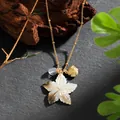 Detail of Hawaiian style necklace featuring mother of pearl shell and golden fish charm - Star Flower Fish Style (HWNX878ST-7)