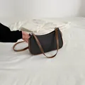Borsa a mezzaluna in tessuto nero con tracolla marrone e cerniera argentata - Nero