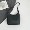 Minimalist black pebble leather hobo shoulder bag with elegant gold foil lettering - Black