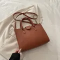 Minimalist dark brown lychee texture tote bag with golden hardware and long strap - Brown